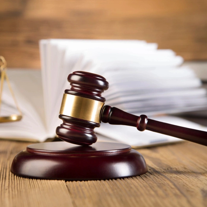 A wooden gavel sitting on top of a table.