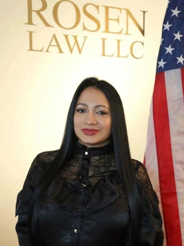 A woman standing in front of an american flag.