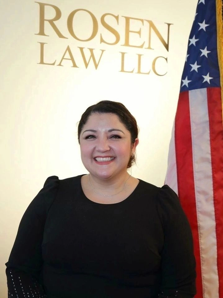 A woman standing in front of an american flag.