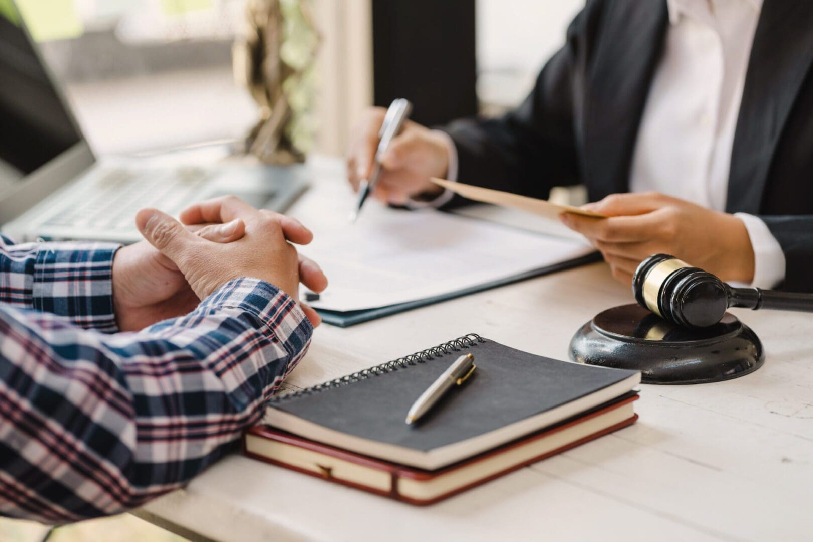 Two people engaged in a discussion over documents at a table.